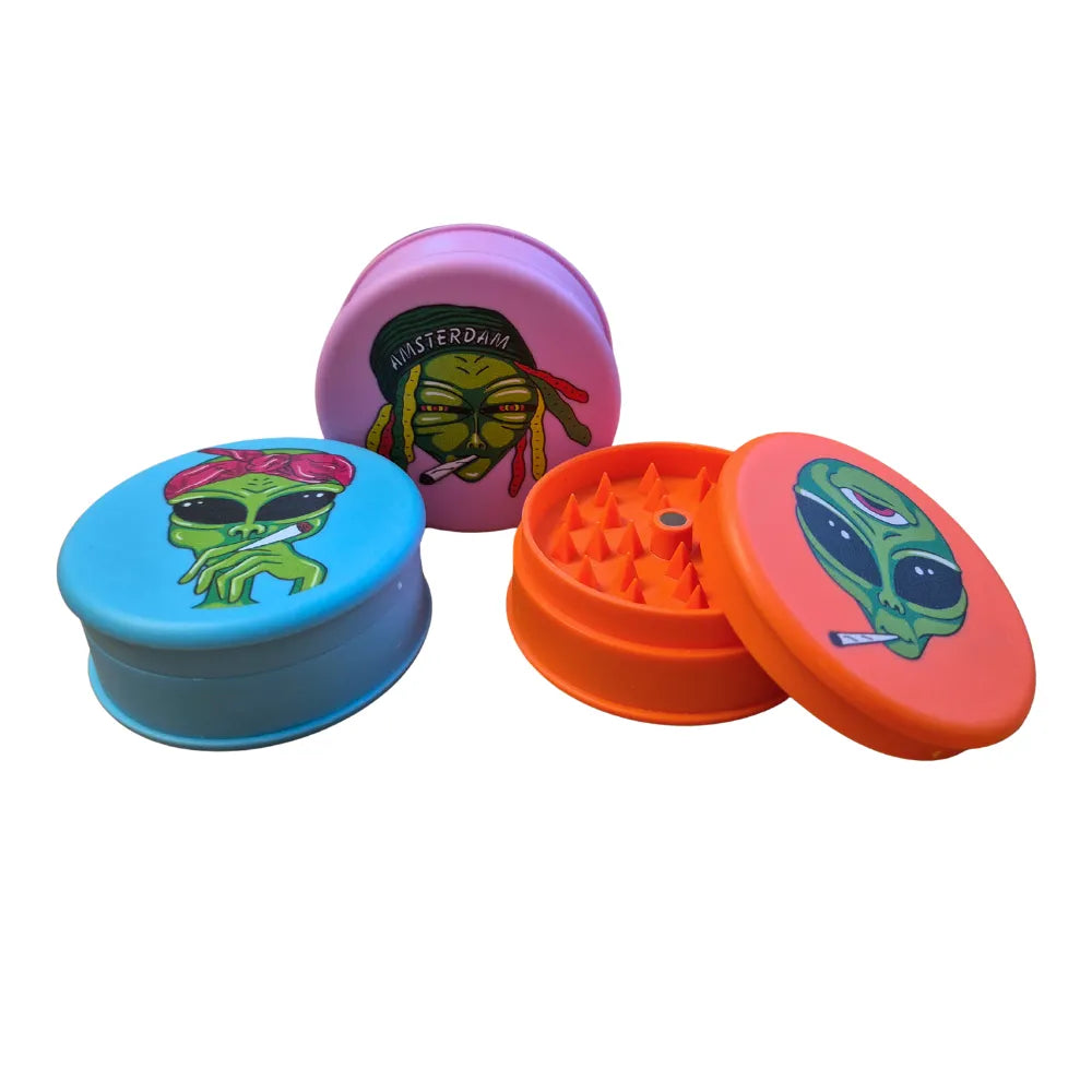 Three colourful Magic Leaf "Print-Collection" plastic grinders with alien inspired designs.