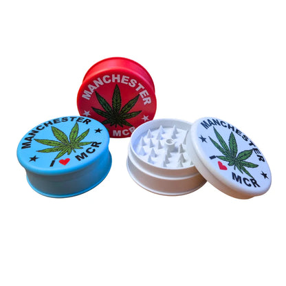 Three colourful Magic Leaf "Print-Collection" plastic grinders with "I Heart Manchester" inspired designs.