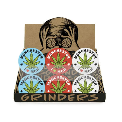Pack of Manchester Grinders with cannabis leaf design on a cardboard box