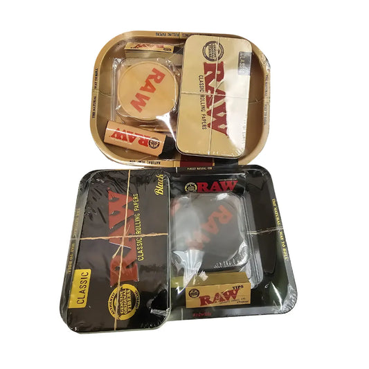 Non authentic raw rolling trays with various accessories on a white background