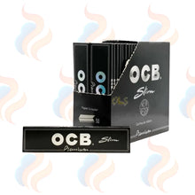 OCB Slim rolling paper packaging with decorative smoke effects on a white background