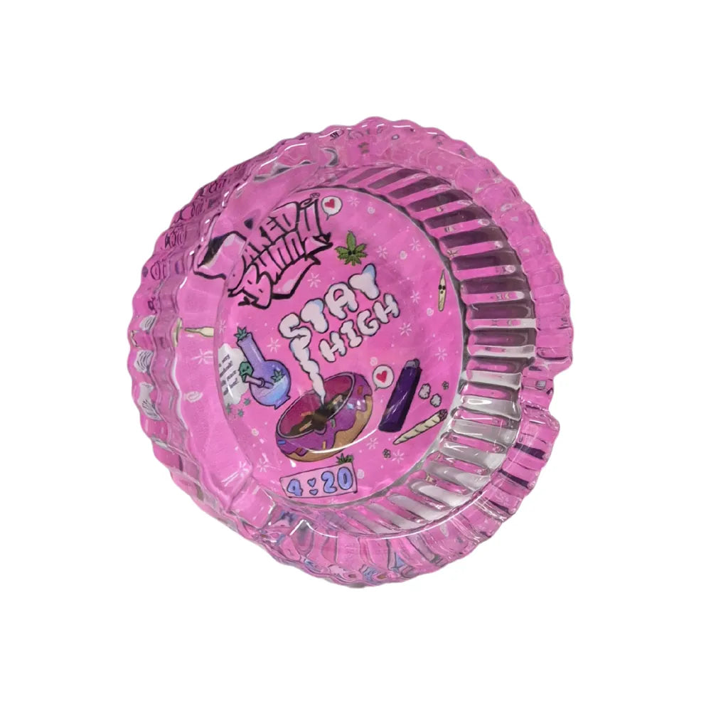 Transparent pink glass ashtray with a printed "stay high" design and 'Baked Bunny' branding on a white background