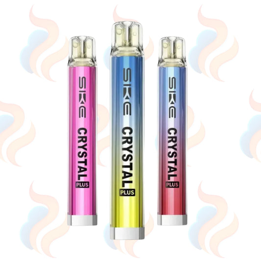 Three SKE Crystal Plus vape devices in pink, blue, and red on a white background with smoke effects.