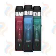 Three Vaporesso Xros Pro vaping devices in red, blue, and green on a white background with subtle smoke effects.